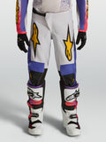 Alpinestars ungdom Fluid Drag byxor, vita och blå motocrossbyxor med gul grafik, ergonomisk passform för terrängkörning.