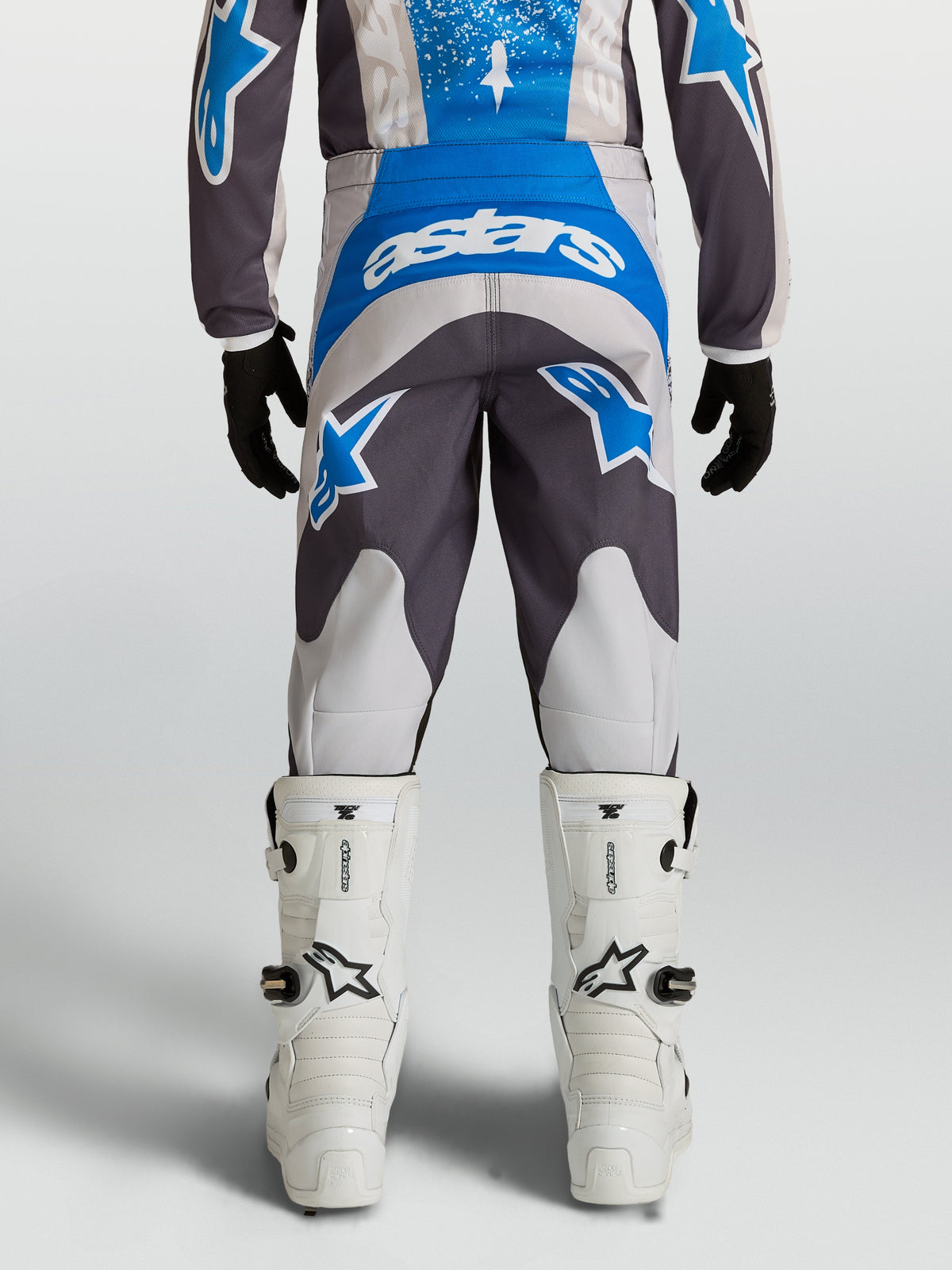 Alpinestars Youth Fluid Drag Pants in blue and gray, durable motocross pants with a pre-curved riding fit.