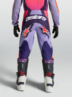 Alpinestars ungdom Fluid Hunt byxor, lila och rosa motocrossbyxor med stjärnlogotyper och hållbar textilkonstruktion.