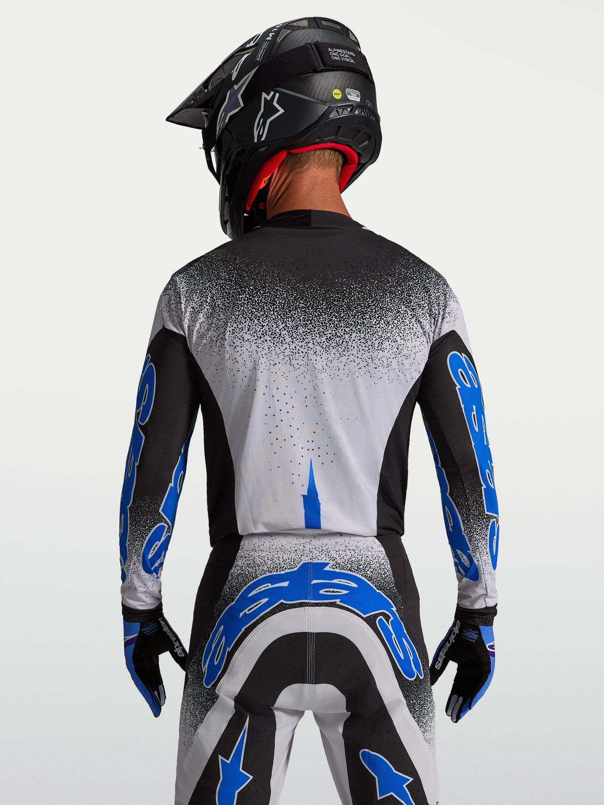 Alpinestars Supertech Hiten AFD-tröja, motocrossracingtröja för herr, svart och blå, vy bakifrån som visar atletisk passform och teknisk flerskiktsdesign.