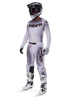 Motocross rider wearing 2025 Supertech Maker Pants in Silver Black, coordinated with a matching silver and grey jersey, black and white helmet, and white racing boots, featuring technical athletic fit for professional off-road performance.