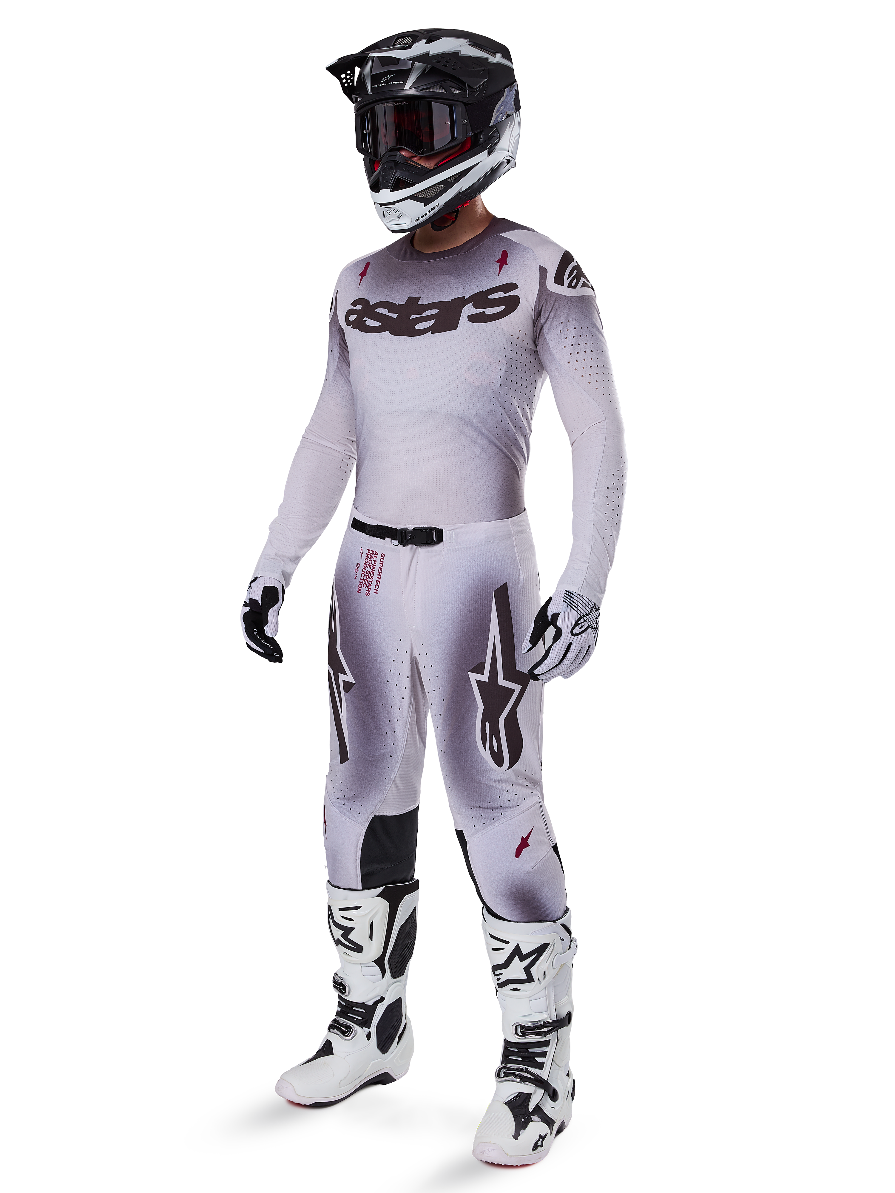 Motocross rider wearing 2025 Supertech Maker Pants in Silver Black, coordinated with a matching silver and grey jersey, black and white helmet, and white racing boots, featuring technical athletic fit for professional off-road performance.