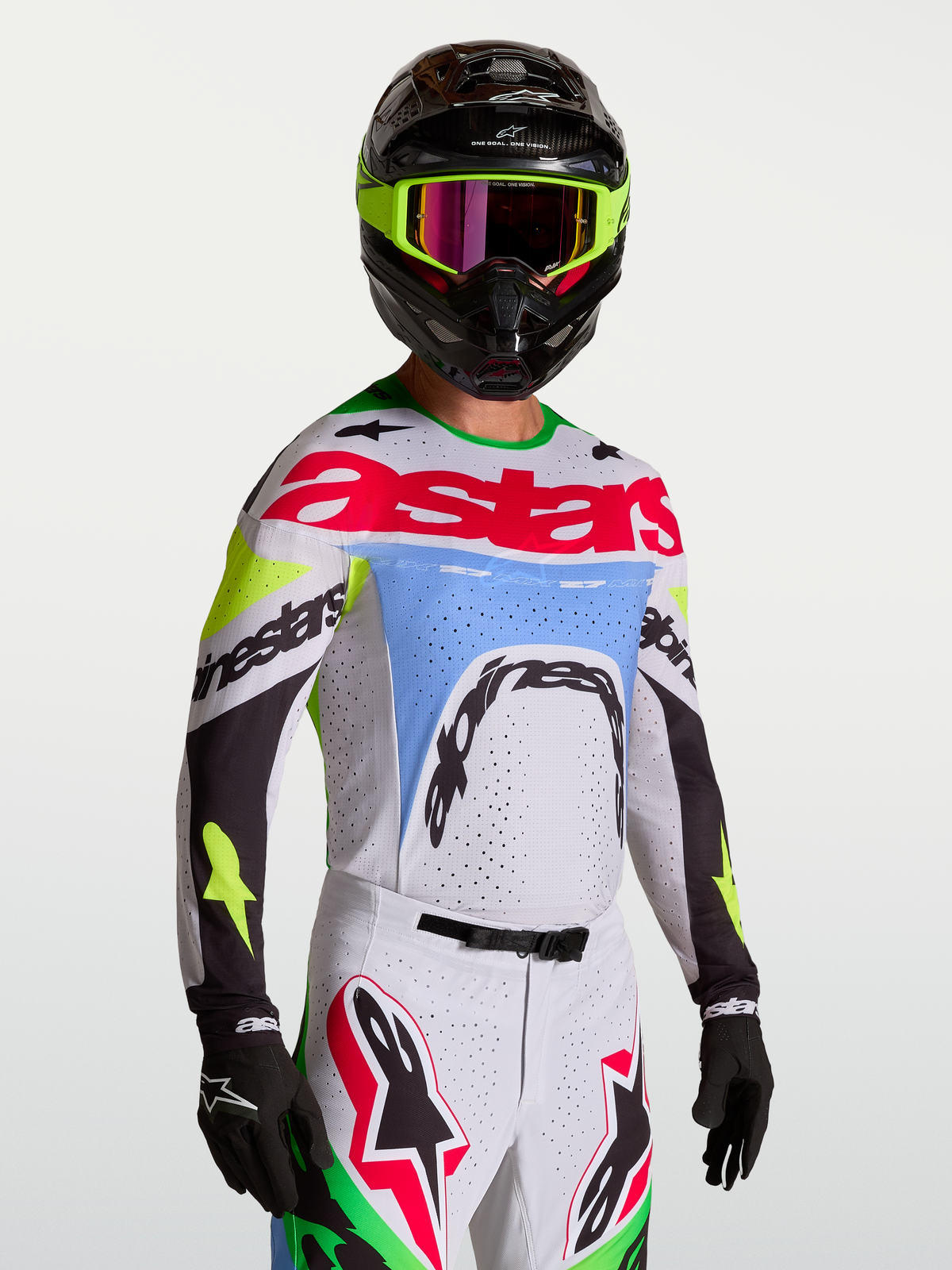 Alpinestars Supertech Dyna tröja, motocrosströja i ljuslila och grön fluo med laserskuren ventilation för terrängkörning.