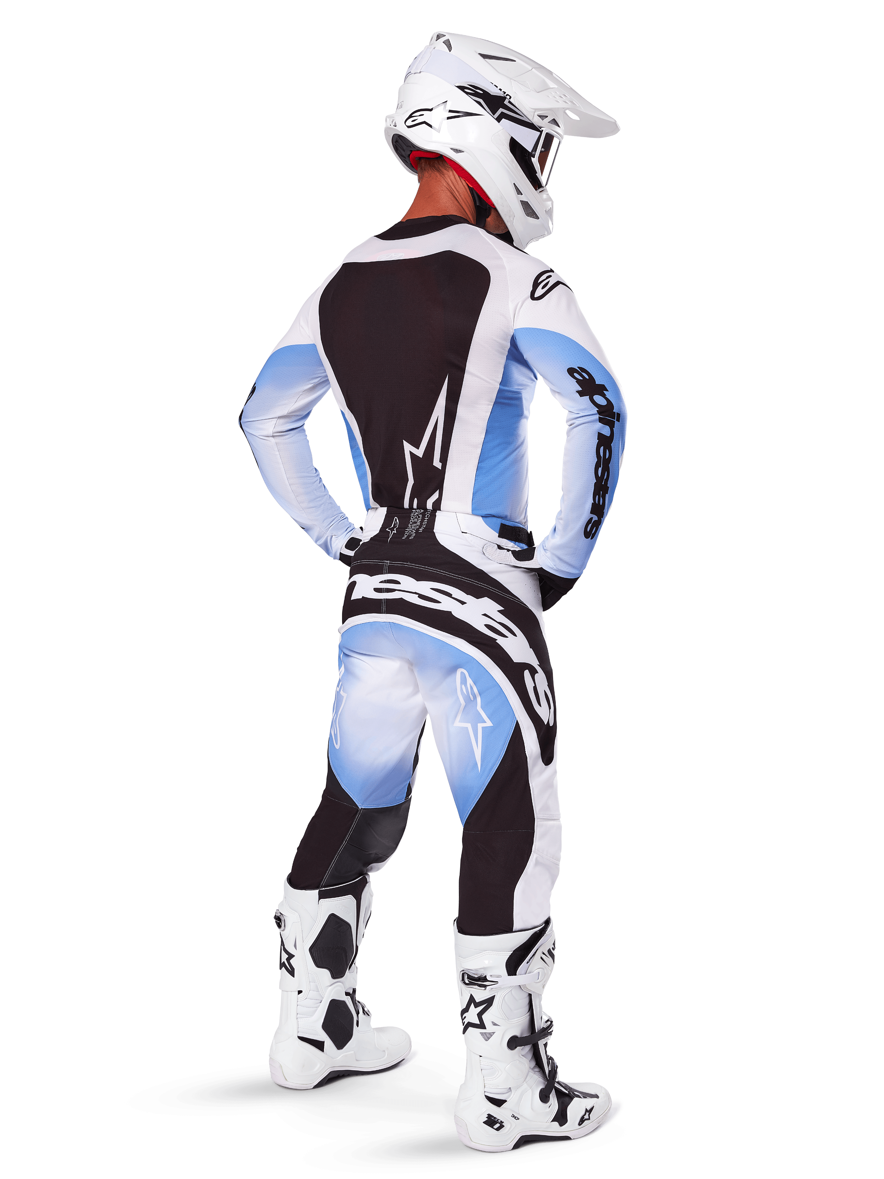Motocross rider wearing complete racing gear, 2025 Techstar Melt Gear Set, White and Light Blue jersey with black back panel, matching pants with blue gradient and black accents, white helmet, white and black boots, coordinated outfit for off-road racing