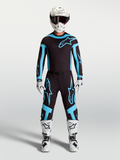 Alpinestars Supertech Vesta tröja och utrustningsset, svart och turkos motocrossutrustning för herr, vita stövlar och hjälm.