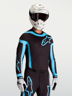 Alpinestars Supertech Vesta tröja, svart och turkos motocross-tröja för herr med laserutskurna ventiler och racingpassform.