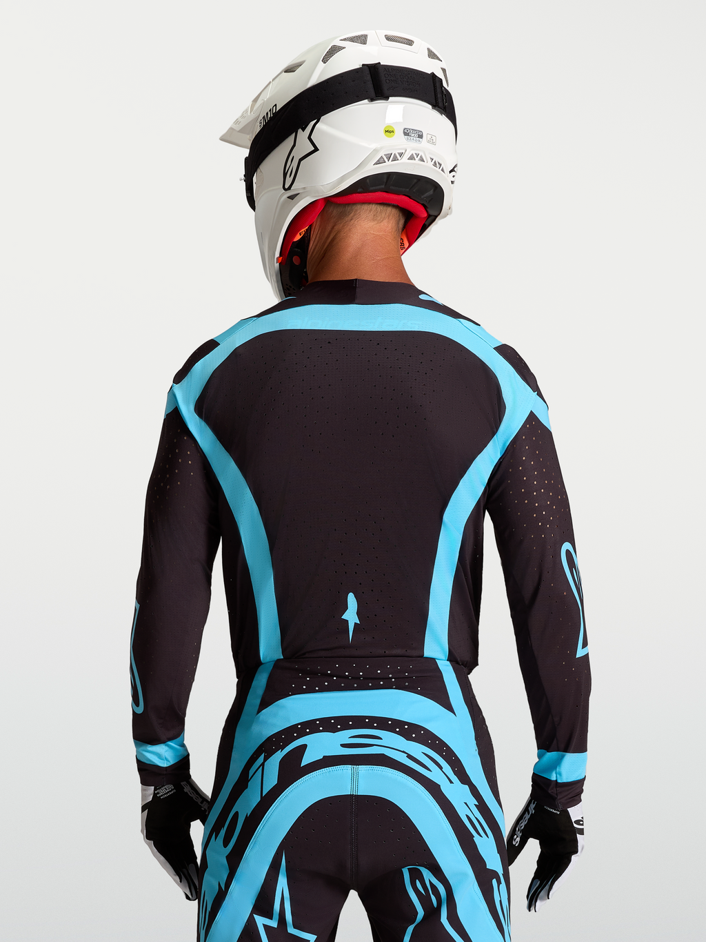 Alpinestars Supertech Vesta tröja, svart och turkos pro-level motocrosströja med stretchmesh, ryggvy på modell.