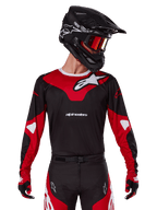 Alpinestars 2025 Racer Veil Jersey, Motocross Jersey, Black and Bright Red, worn with matching pants, black helmet, and red goggles, featuring bold white logos and a sleek racing design, performance gear for off-road motocross