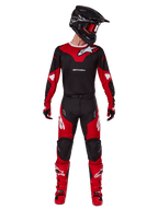 Motocross rider wearing the Alpinestars 2025 Racer Veil gear set, Black and Bright Red jersey with white Alpinestars logo, matching motocross pants, black helmet with red goggles, and red boots, complete performance outfit for off-road riding