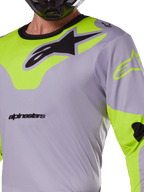 Alpinestars 2025 Racer Veil Jersey, Motocross Jersey, Gray and Yellow Fluo, featuring a large black Astars logo on the chest, neon yellow shoulder and sleeve panels, technical mesh fabric for off-road racing