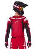 Alpinestars 2025 Fluid Haul Jersey, Motocross Jersey, Bright Red and Black, worn as part of a complete gear set with matching pants and gloves, black helmet with yellow lens goggles, white branding and logos, high-performance off-road racing apparel