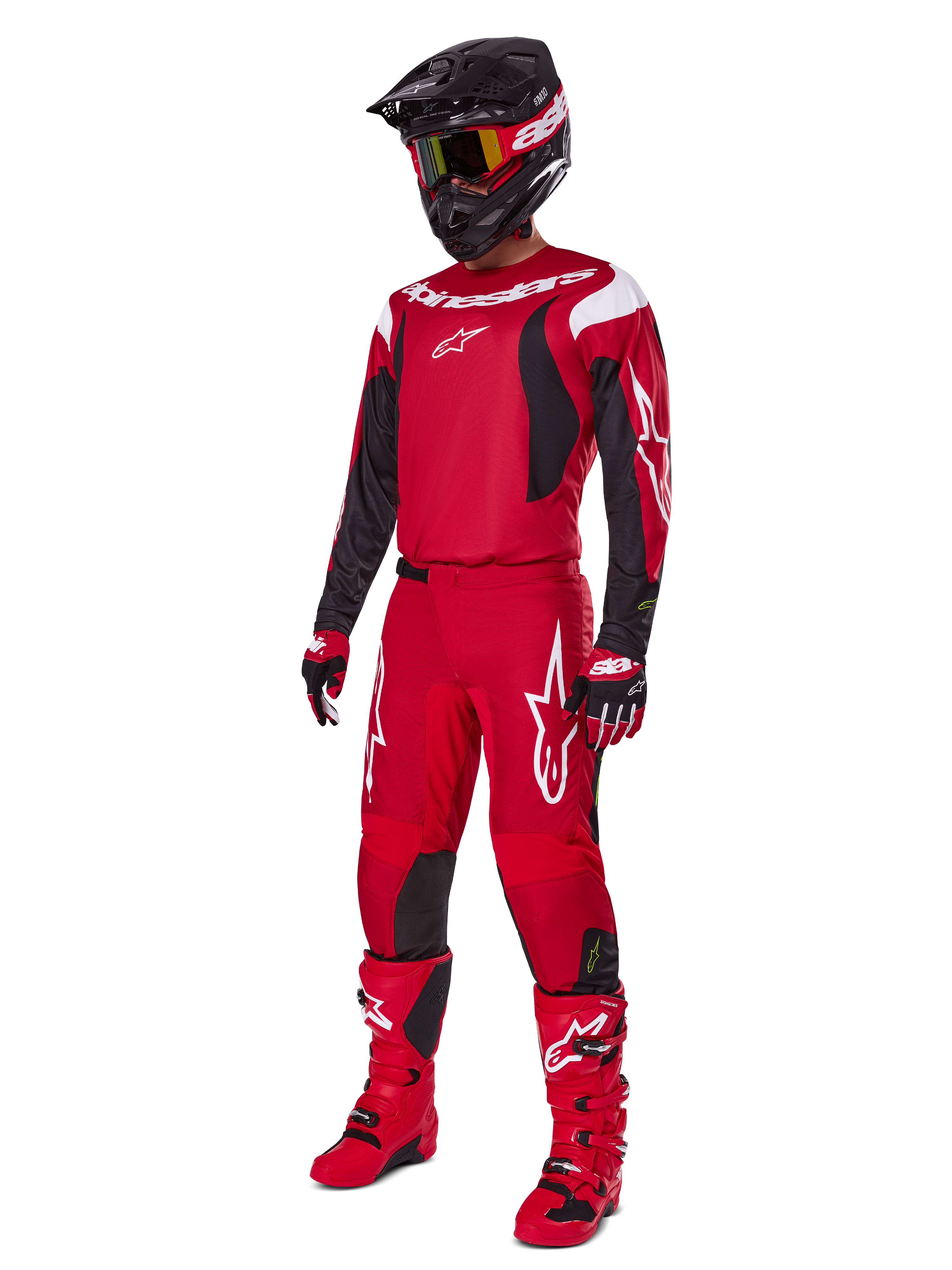 Motocross rider wearing Alpinestars 2025 Fluid Haul Gear Set, Bright Red with Black and White accents, complete outfit including jersey, pants, helmet, boots, and gloves, designed for off-road performance and protection