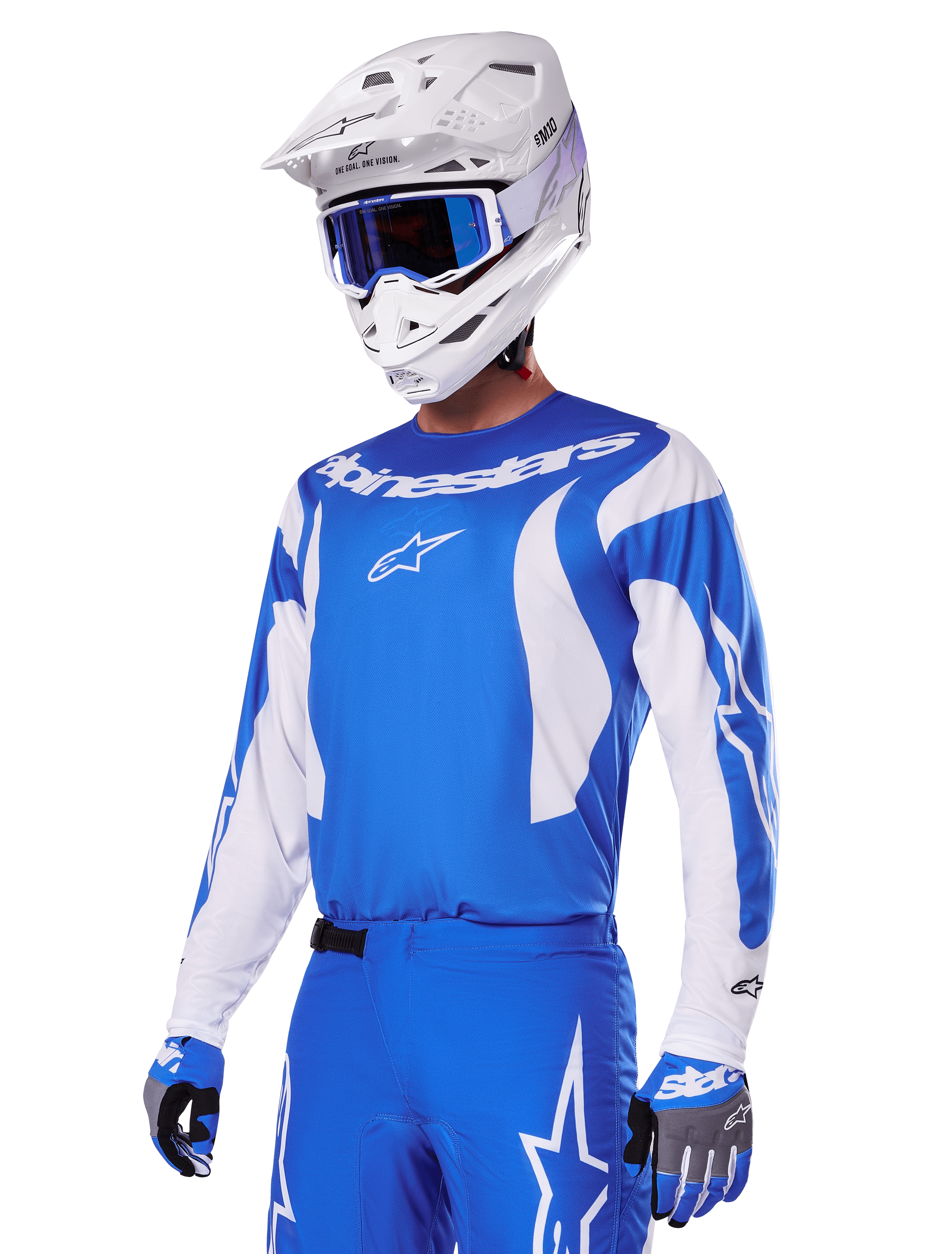Motocrossförare som bär Alpinestars 2025 Fluid Haul utrustningsset i blått och vitt, blå tröja med vita detaljer, matchande blå byxor med stjärnlogotyper, vit hjälm med blå goggles, koordinerade blå och grå handskar, komplett racingoutfit för terrängkörning