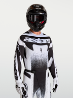 Alpinestars Techstar Swan tröja, svart och vit motocrosströja för herrar med atletisk passform och laserskuren ventilation.