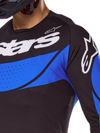 Alpinestars 2025 Techstar Dreem tröja, svart och blå ventilerad motocrosströja med laserskurna perforeringar.