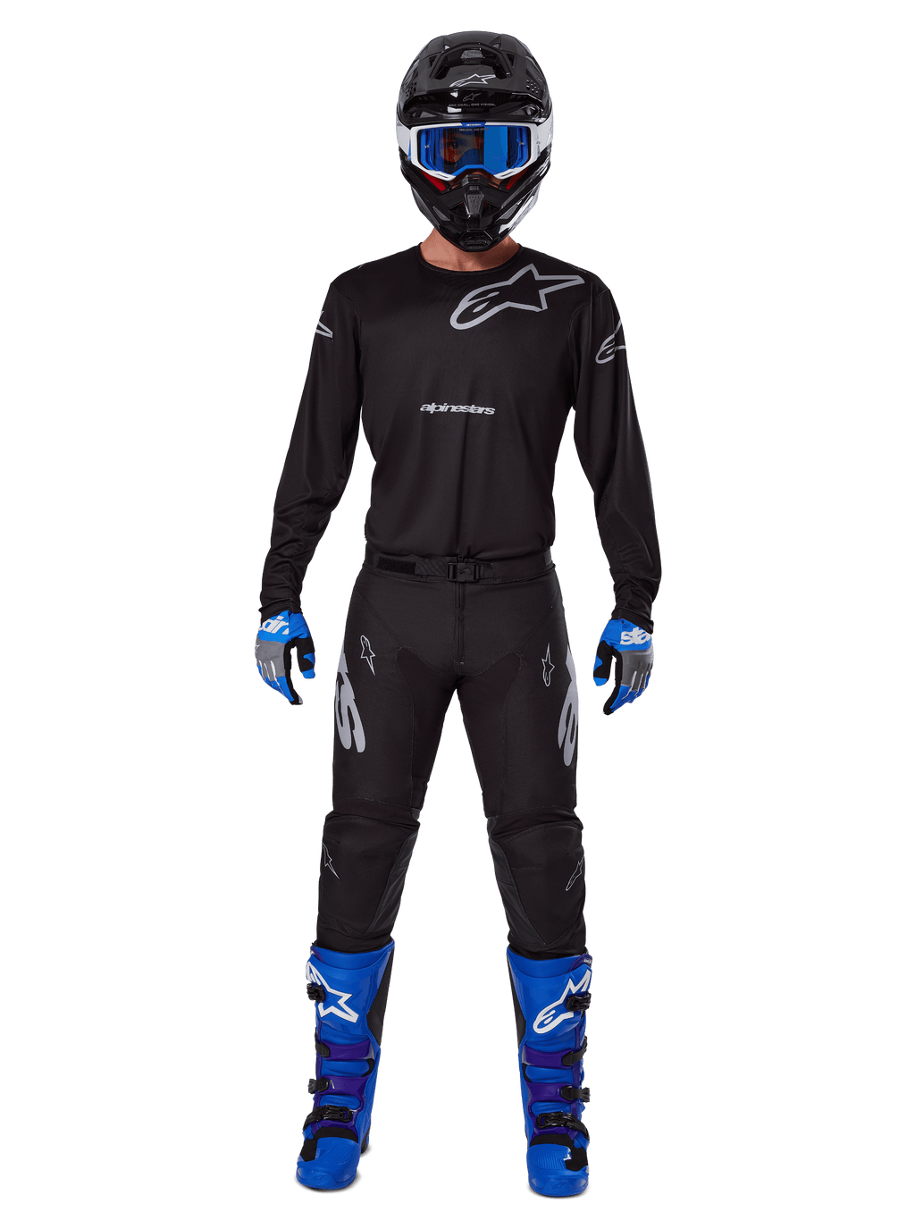 Alpinestars 2025 Racer Graphite Gear Set, Motocross rider wearing complete racing gear, black long-sleeve jersey with gray Alpinestars logos, black pants, black helmet with blue goggles, blue and gray gloves, blue and black boots, coordinated outfit for off-road motocross racing