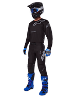 2025 Racer Graphite Gear Set, complete motocross outfit, black and gray jersey and pants with silver logos, black helmet with blue-tinted goggles, blue and black gloves, bright blue boots, professional off-road racing gear