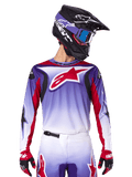 Alpinestars 2025 Fluid Wurx Jersey, Motocross Racing Jersey, Purple to White Gradient, Red star logo and accents, athletic fit, worn with matching pants, black helmet, and red gloves