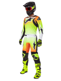 Alpinestars 2025 Fluid Wurx Gear Set, Motocross Racing Outfit, Neon Yellow and Orange gradient, complete kit with jersey and pants, black helmet with orange goggles, neon yellow boots and gloves, athletic design for off-road performance