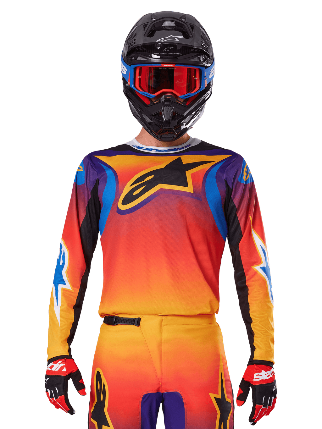 Alpinestars 2025 Fluid Wurx tröja, mångfärgad motocrosströja med orange och röd toning och lila accenter, bärs med matchande utrustning, svart hjälm med blå och röda goggles och röda handskar, med en stor svart stjärnlogotyp på bröstet.
