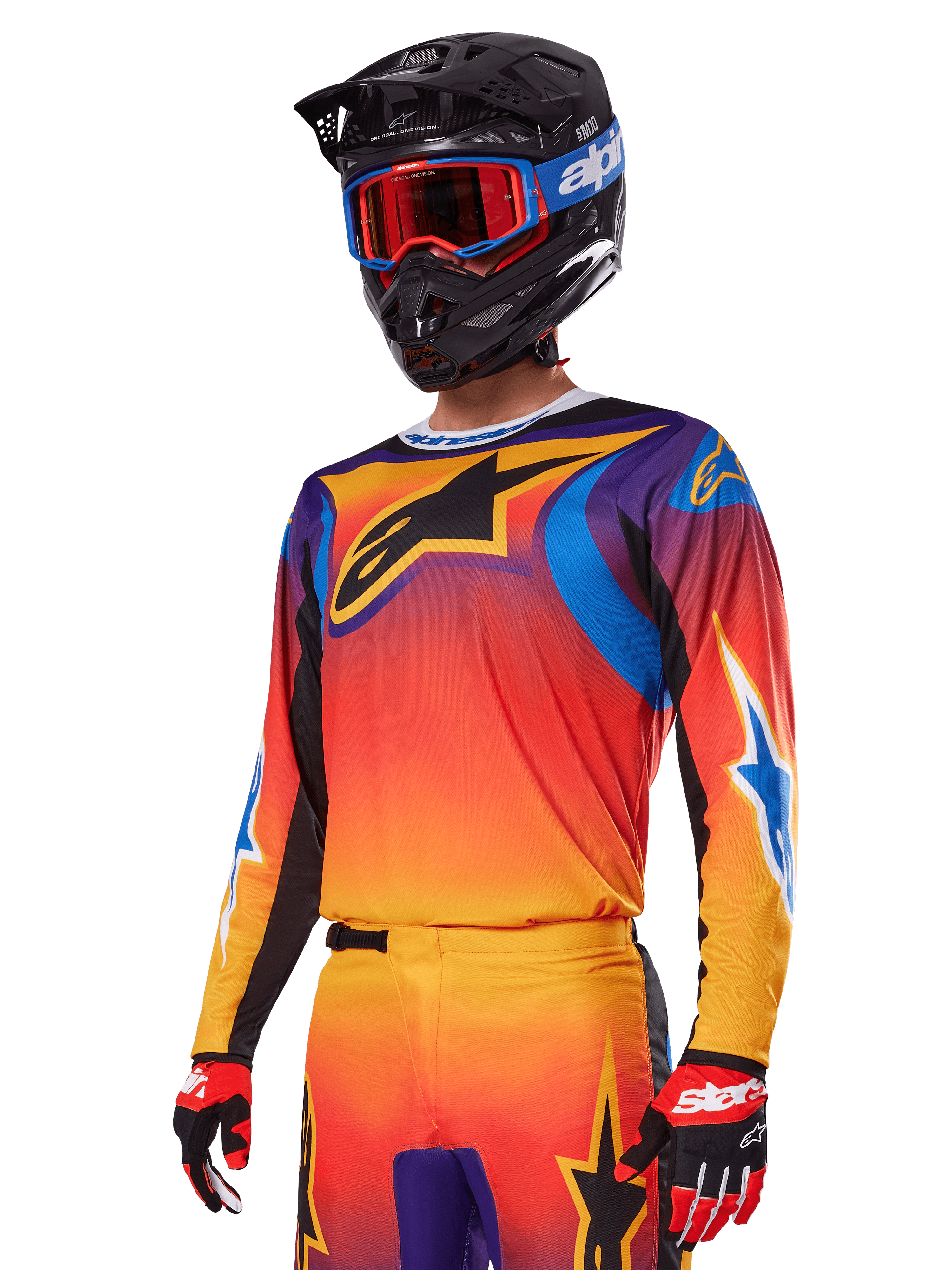 Alpinestars 2025 Fluid Wurx utrustningsset, motocross-set, orange, lila och blå gradient, med en stor svart A-stars-logotyp, bärs med en svart hjälm och blå goggles, koordinerad outfit för professionell offroad-racing