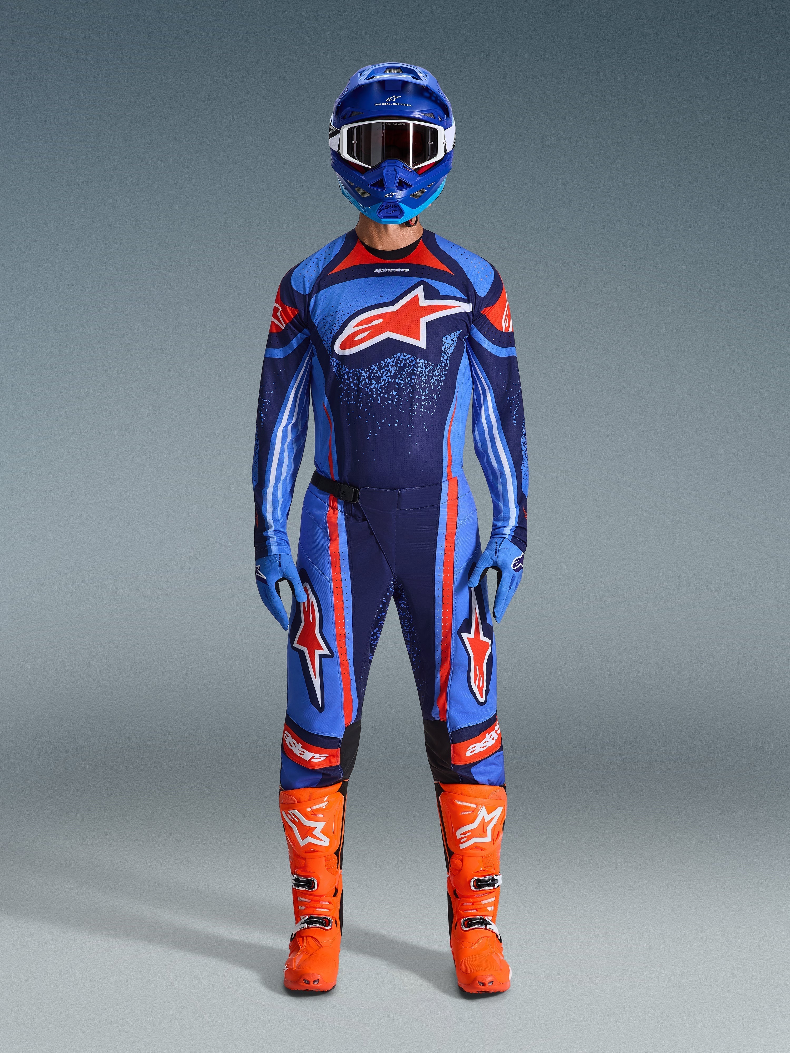 Alpinestars 2026 Techstar Nomur Gear Set, Motocross Racing Gear, Dark Navy, Orange and UCLA Blue, complete riding outfit with blue helmet, matching jersey and pants, blue gloves, and bright orange boots, featuring star logos, performance off-road protection