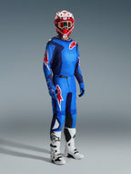 Motocrossförare bär Alpinestars 2026 Fluid Grid-tröja i Blue Red, matchande motocrossbyxor, vita och svarta stövlar och en röd och vit hjälm, professionellt utrustningsset för offroad-prestanda.