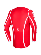 Alpinestars 2026 Fluid Apex Jersey, röd och vit, baksida av långärmad motocrosströja med vita böjda accentlinjer, stjärnlogotyp längst ner och vit Alpinestars-text på ärmarna, designad för offroadkörning