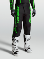 Alpinestars Fluid Apex V2 byxor, svarta och neongröna motocrossbyxor för herr, förstärkt 600D polytyg och stretchpaneler.