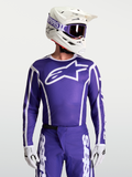 Alpinestars Fluid Apex V2 tröja, motocrosströja i djupt blått och vitt på modell, fukttransporterande polytyg och ergonomisk atletisk passform.