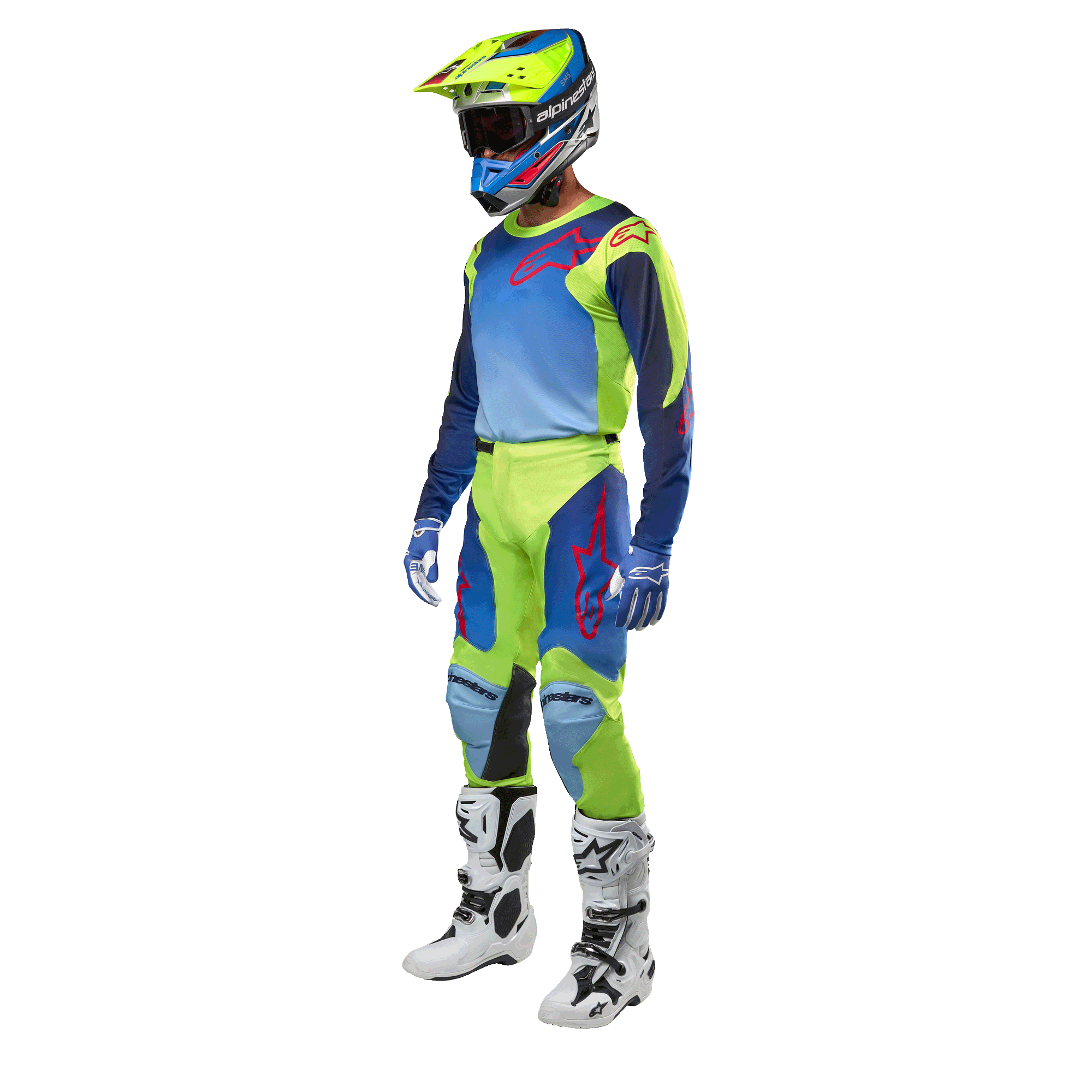 Alpinestars 2024 Racer Hoen tröja, motocrosströja, neongul och mörkblå, bärs av en förare med matchande byxor, hjälm och vita stövlar, professionell racingutrustning för terrängkörning