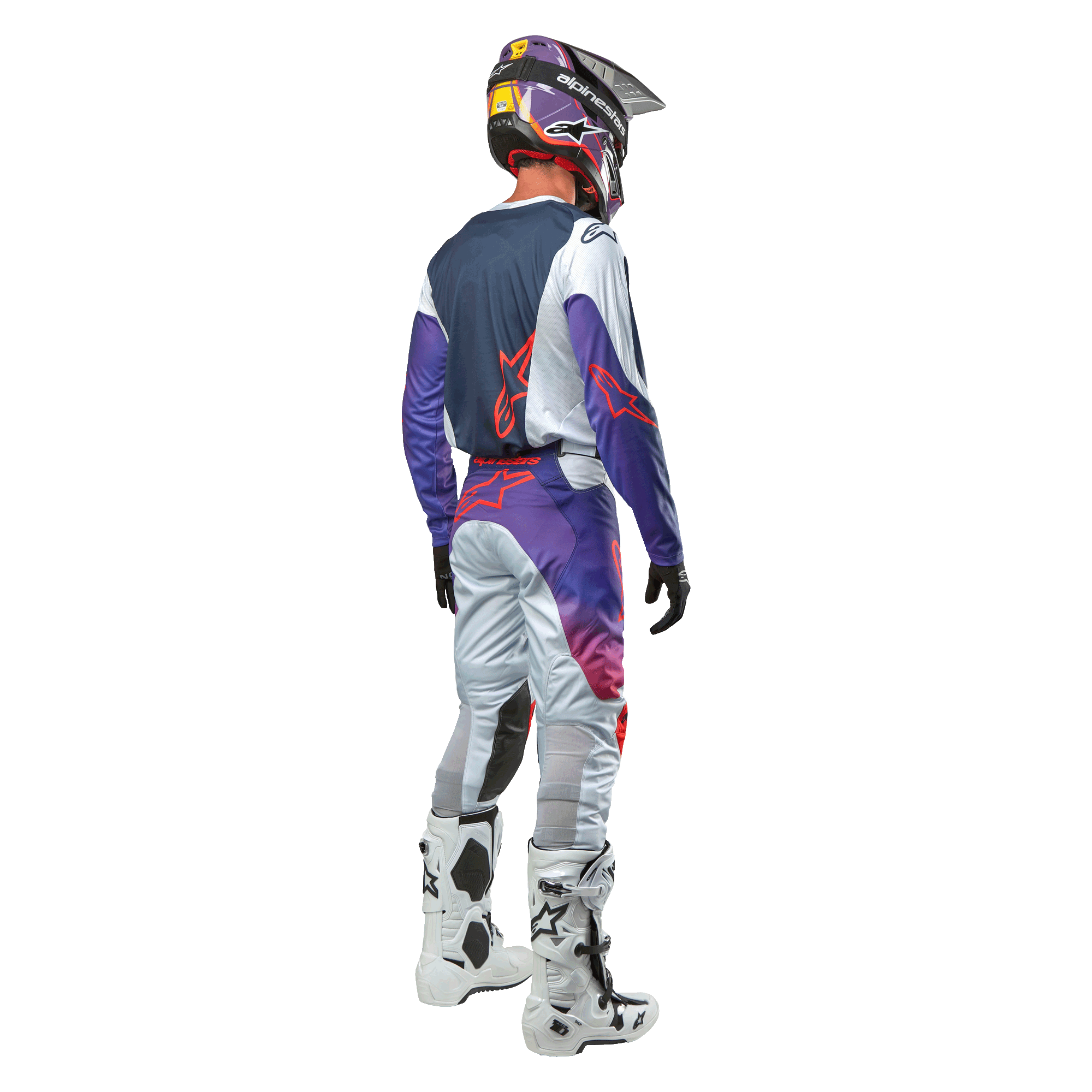 Motocrossförare sedd bakifrån bärande Alpinestars 2024 Racer Hoen Jersey i Light Gray Hot Orange Black, mörkblå ryggpanel med orange stjärnlogotyp, lila ärmar, bärs tillsammans med matchande racingbyxor och vita stövlar.