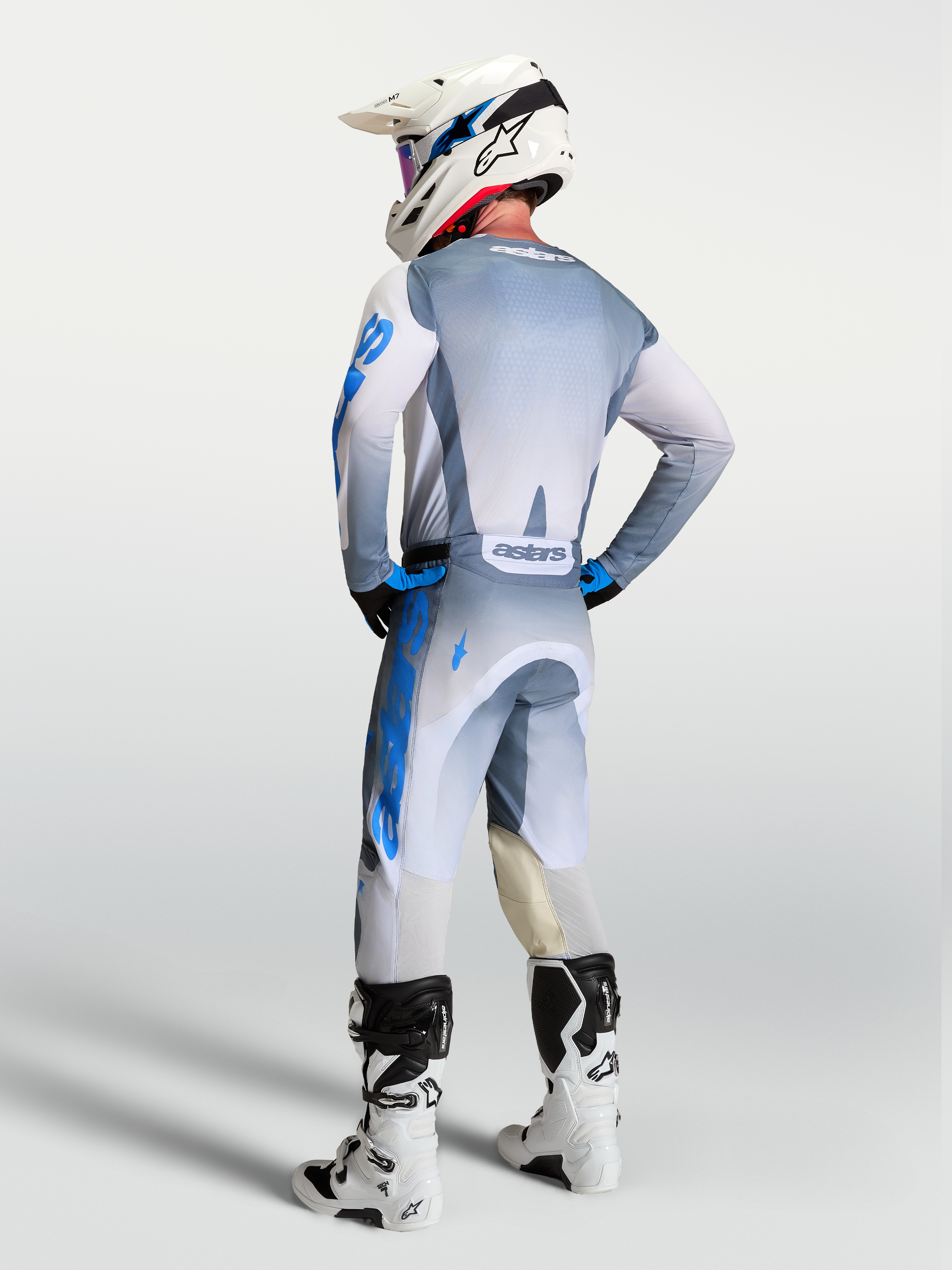Alpinestars Racer Amber Pants and 2027 Gear Set, motocross racing apparel, gray and blue, rear view on a rider.