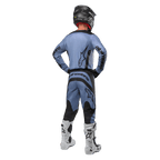 Motocross rider from behind wearing the Alpinestars 2024 Fluid Lurv Jersey and matching pants in Light Blue and Black, featuring black branding on the back and sleeves, paired with a black helmet and white boots.