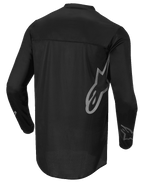 Alpinestars Fluid Graphite tröja, motocrosströja, svart och mörkgrå, vy bakifrån, med stor grå Alpinestars-logotyp på sidan och grafik på ärmarna, lätt fukttransporterande material för terrängkörning