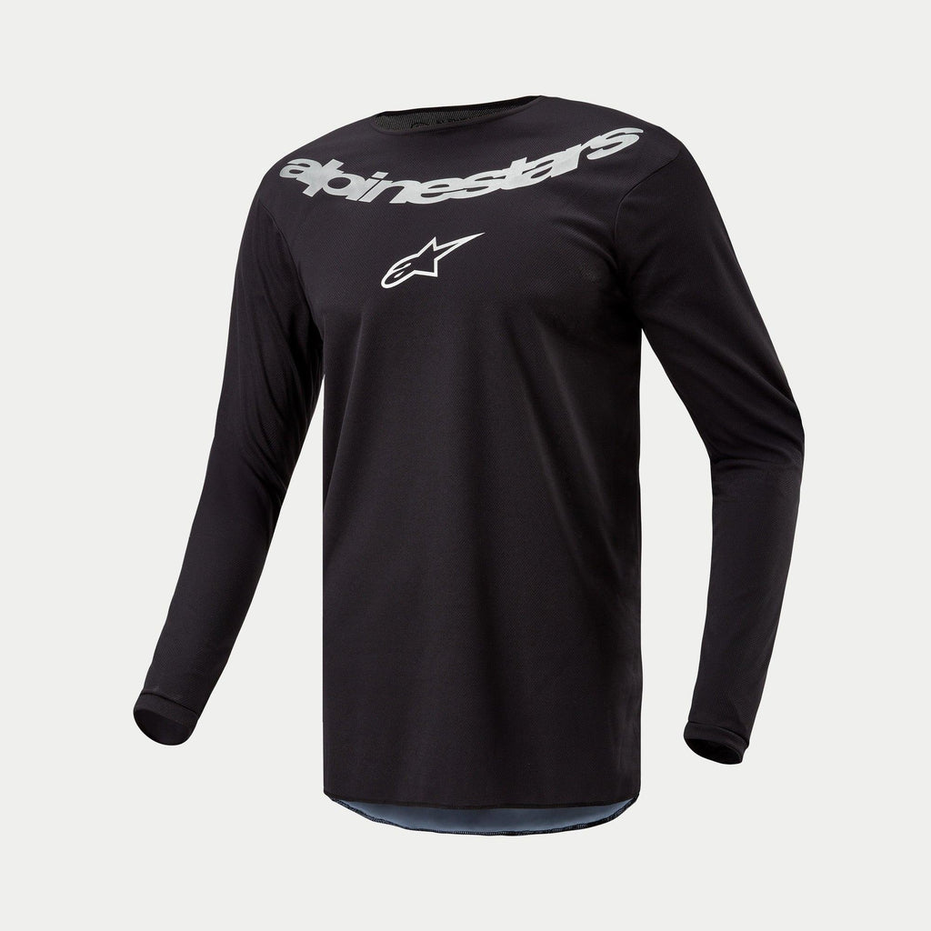 Alpinestars 2024 Fluid Graphite Jersey, Motocross Jersey, Black Silver, long-sleeve performance top featuring large silver Alpinestars branding and star logo on chest, lightweight moisture-wicking poly-fabric for off-road riding