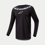 Alpinestars 2024 Fluid Graphite Jersey, Motocross Jersey, Black Silver, long-sleeve performance top featuring large silver Alpinestars branding and star logo on chest, lightweight moisture-wicking poly-fabric for off-road riding