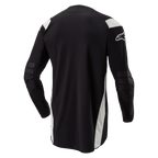 Alpinestars Techdura-tröja, enduro- och motocrosströja, svart med vita detaljer, vy bakifrån med förlängd rygg, förstärkta armbågar och vit Alpinestars-logotyp på ärmen, hållbara kläder för terrängkörning