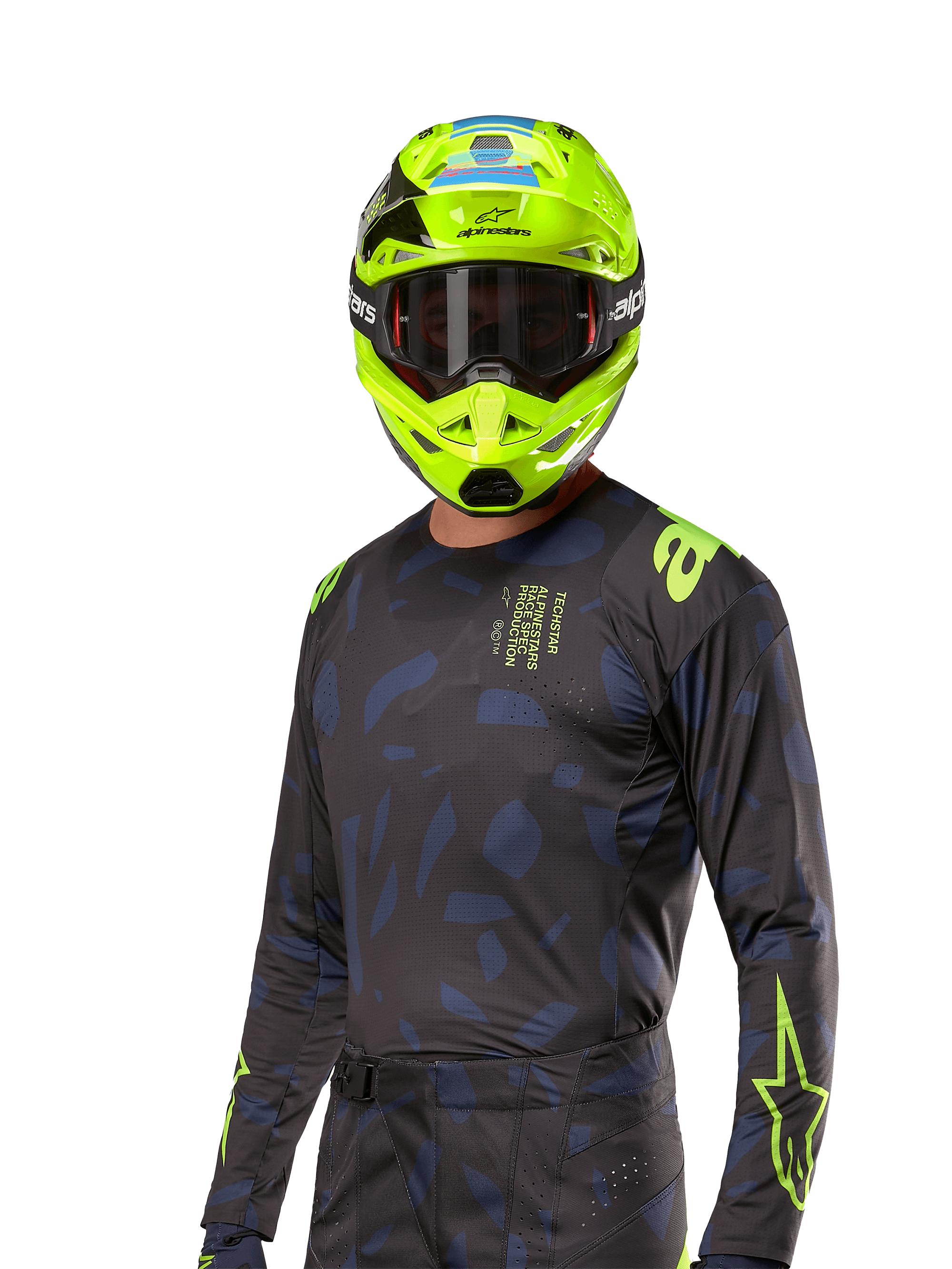 Alpinestars 2024 Techstar Rantera tröja, motocrosströja, svart och marinblå med abstrakta mönster och neongula detaljer, bärs med matchande neongul hjälm, performance fit-design för terrängkörning