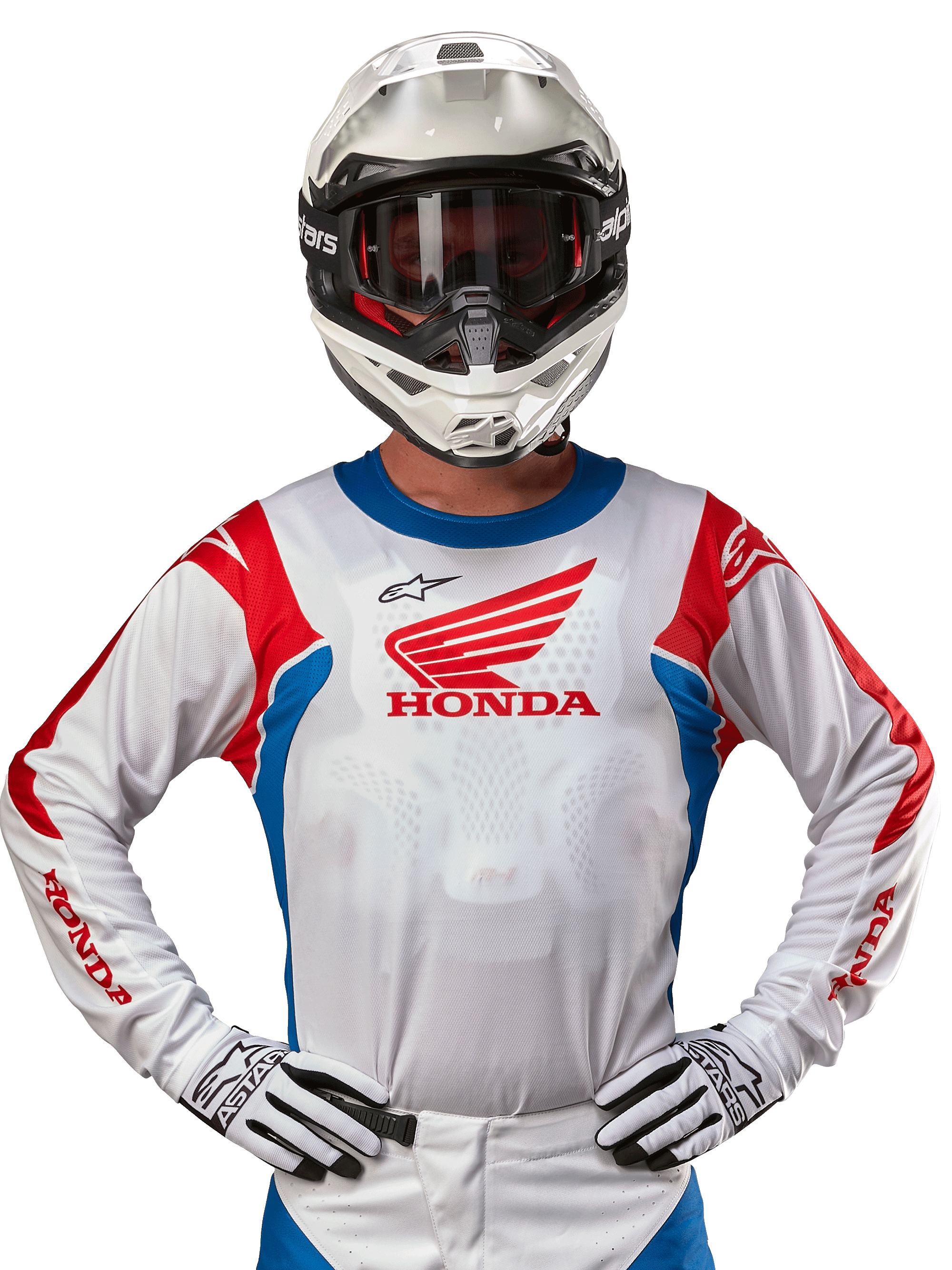 Alpinestars Honda Racer Iconic tröja, vit motocrosströja med röd Honda-logotyp och klarblå och röda detaljer, bärs av en förare med vit hjälm och handskar, prestandautrustning för offroad- och motocrossracing