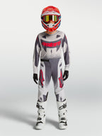 Alpinestars 2027 ungdom Supertech Swan tröja och gear set, grått och vitt motocross-set med röda detaljer.