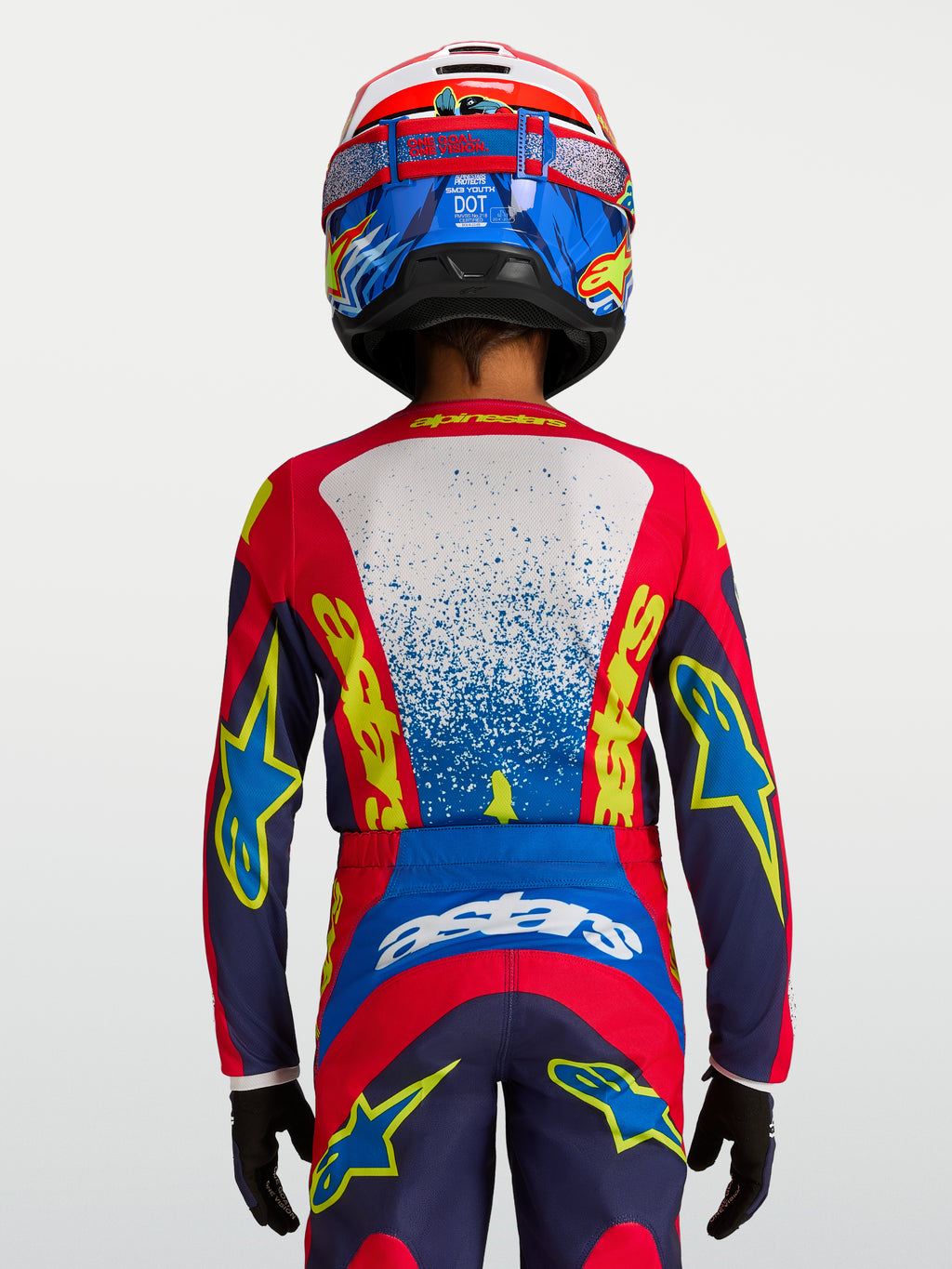 Alpinestars Fluid Drag ungdomströja i blått och rött, teknisk motocrosströja med ergonomisk passform för unga förare.