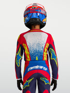 Alpinestars Fluid Drag ungdomströja i blått och rött, teknisk motocrosströja med ergonomisk passform för unga förare.