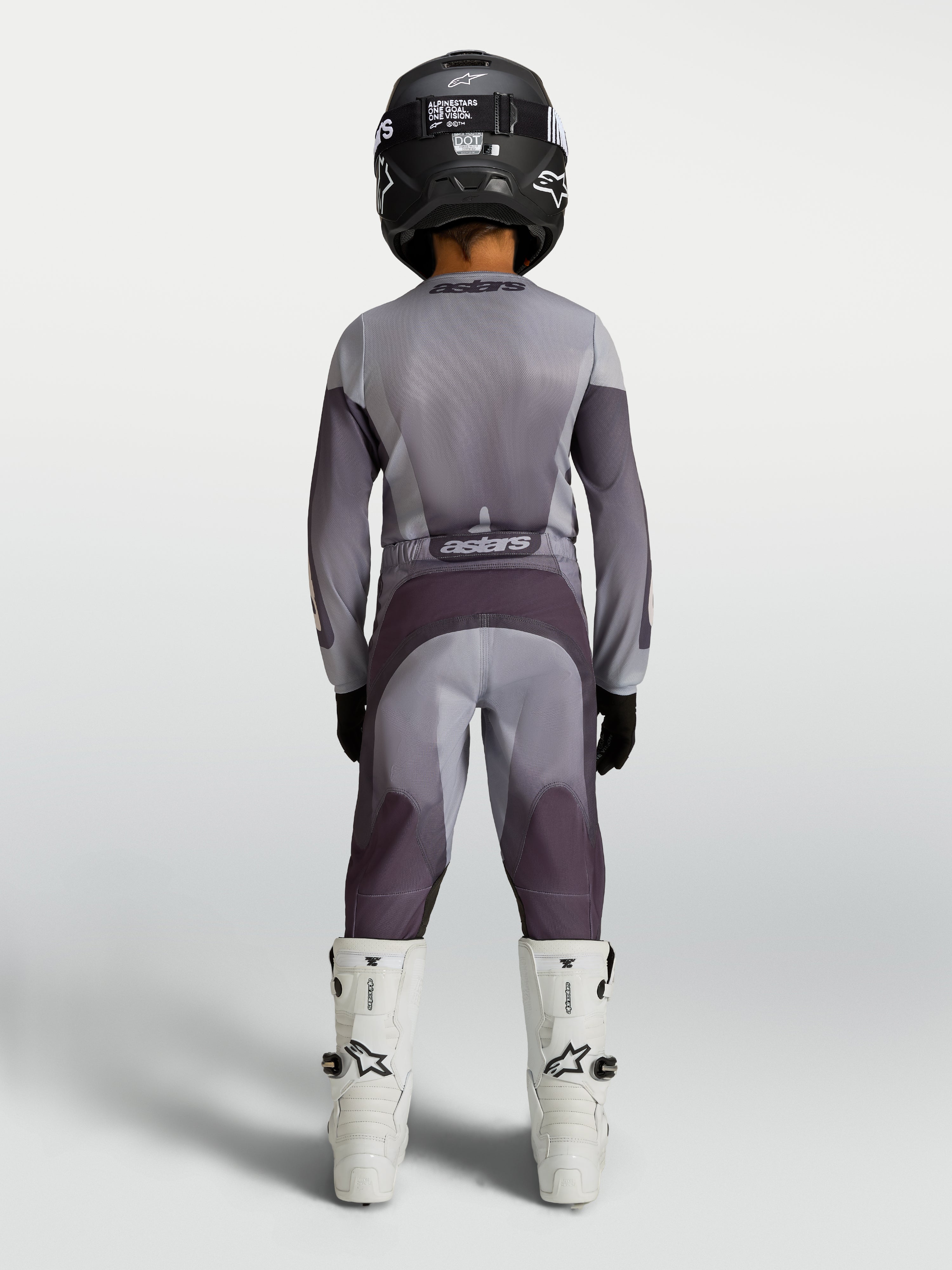 Alpinestars 2027 Youth Fluid Amber Jersey and Gear Set, gray and purple motocross racing gear, rear view on youth rider.