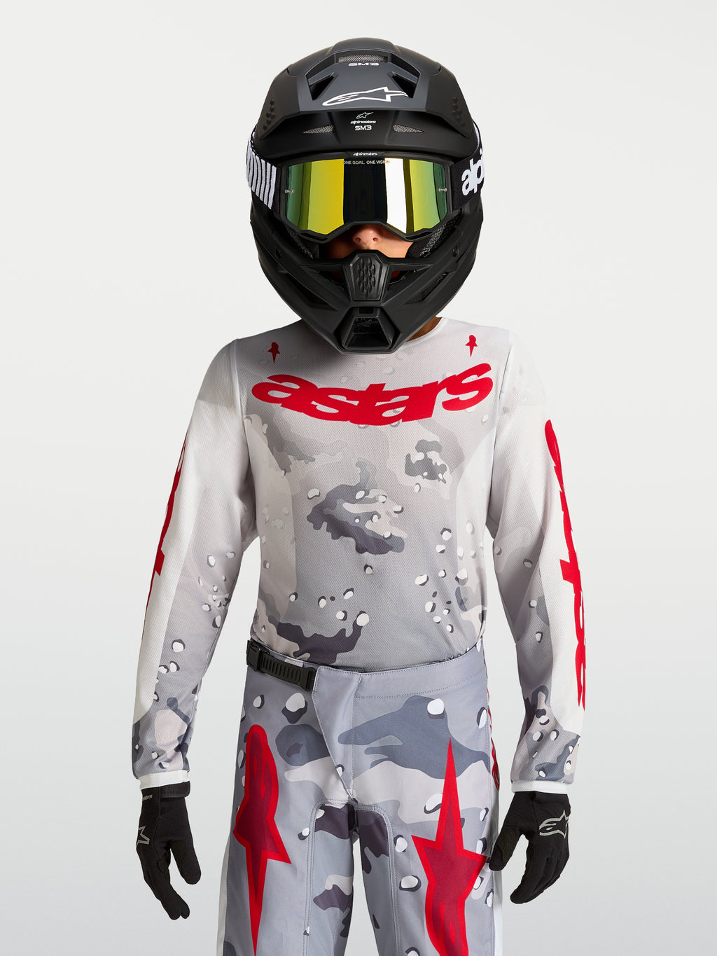 Alpinestars 2027 Ungdom Fluid Lone tröja, grå camo och röd motocrossutrustning, prestandaorienterad textilkonstruktion.