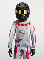 Alpinestars 2027 Ungdom Fluid Lone tröja, grå camo och röd motocrossutrustning, prestandaorienterad textilkonstruktion.
