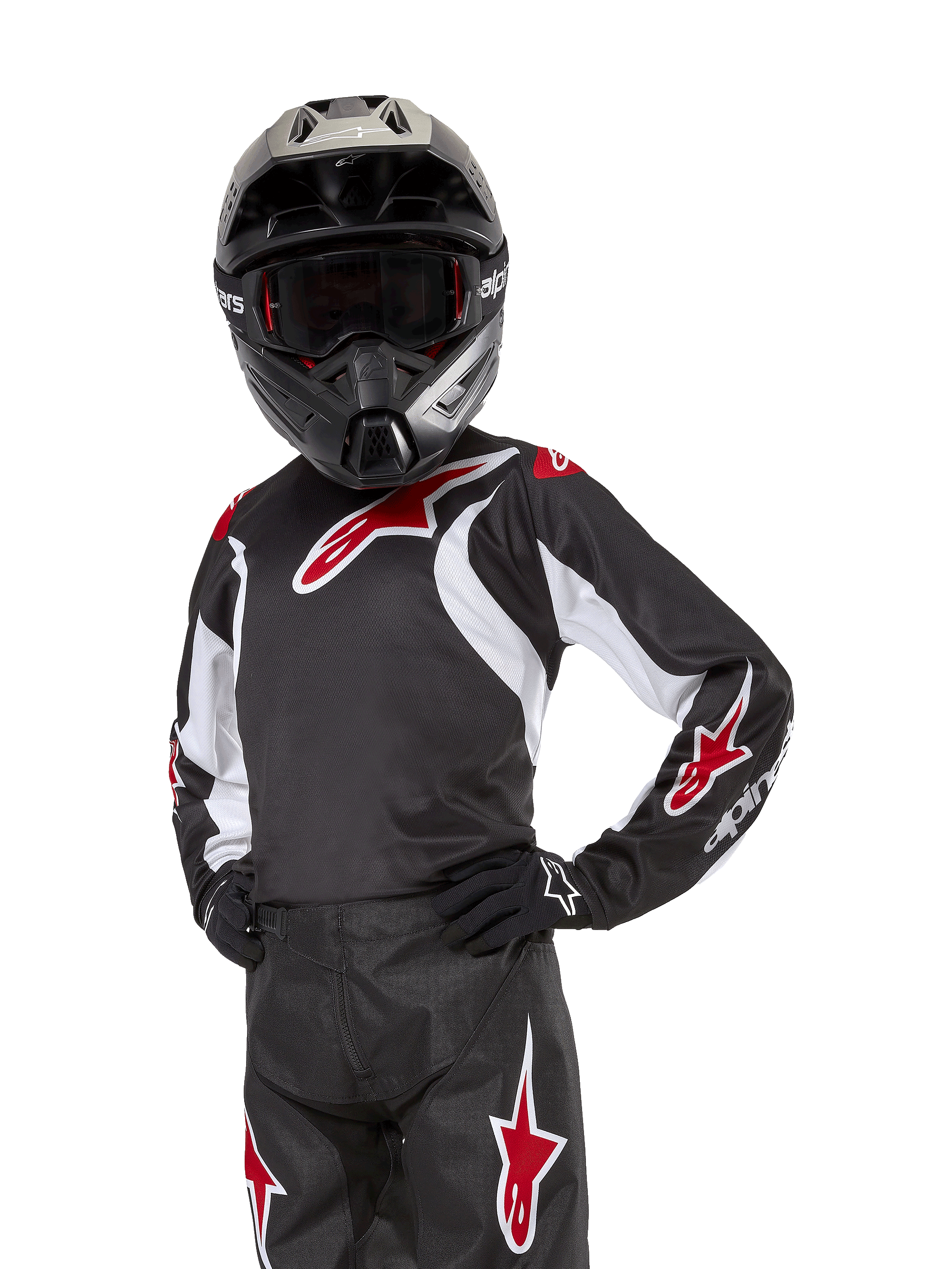 Youth 2024 Racer Lucent Jersey, motocrosströja, svart, vit och röd, bärs av en ung förare med en svart hjälm och matchande byxor, med röda stjärnlogotyper och vita grafiska accenter, prestandakläder för terrängkörning