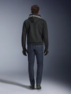 Alpinestars Chrome Superairflow Hoodie, Black motorcycle hoodie with white branding on the hood, viewed from the back, worn with dark blue jeans, black gloves, and black and white boots, urban sport riding gear