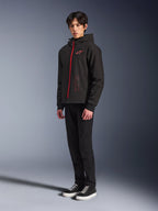 Alpinestars Radium Tech Hoodie, Black Bright Red, urban riding technical hoodie featuring a red front zipper and chest logo, worn by a model with black pants and black sneakers with white soles, full-body studio shot