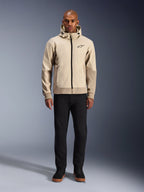 Alpinestars Radium Tech Hoodie in Mastic Aluminum, urban motorcycle hoodie worn by a male model with black pants and black boots, featuring a full-length black zipper, small chest logo, and athletic fit for city riding.
